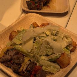 Caesar salad and two steak skewers Caesar salad and two steak skewers