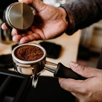The Format Mobile Coffee Company - a person using a coffee grinder - Caterers Near Me The Format Mobile Coffee Company - a person using a coffee grinder - Caterers Near Me