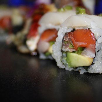 Go Fish - The Amazing Roll is made with yellowtail, tuna, salmon, jalapeno & avocado then topped with fresh scallop & wasabi sasa. - Japanese Near Me - Denver, Colorado Go Fish - The Amazing Roll is made with yellowtail, tuna, salmon, jalapeno & avocado then topped with fresh scallop & wasabi sasa. - Japanese Near Me - Denver, Colorado
