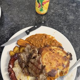 Masa, steak, egg, sausage, beans, plantains, and rice.