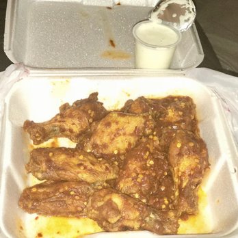Wings & BBQ - a tray of food with a spoon in it - Chicken Wings Near Me - Smyrna, Georgia