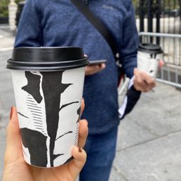 a woman holding a cup of coffee