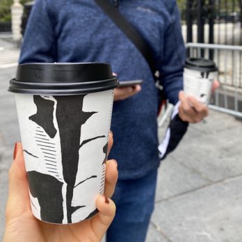 Birch Coffee - a woman holding a cup of coffee - Coffee & Tea Near Me - New York, New York