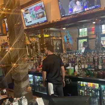 Pearl & Peril - a man standing at the bar - Bars Near Me - Raleigh, North Carolina Pearl & Peril - a man standing at the bar - Bars Near Me - Raleigh, North Carolina