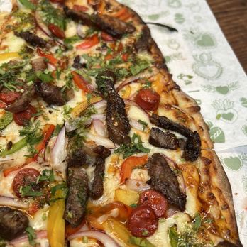 El Lugar de Nos - Thin crust pizza with ribeye and sausage. - Cocktail Bars Near Me - Tecate, BCN