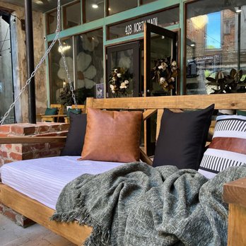 The Magnolia Coffee - a wooden swing bed with pillows and blankets - Coffee & Tea Near Me - Water Valley, Mississippi The Magnolia Coffee - a wooden swing bed with pillows and blankets - Coffee & Tea Near Me - Water Valley, Mississippi