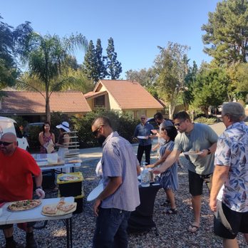 Wicked Pizza Pies - Bryan (in red) serving up amazing pizza to very happy guests. - Caterers Near Me - Norco, California Wicked Pizza Pies - Bryan (in red) serving up amazing pizza to very happy guests. - Caterers Near Me - Norco, California