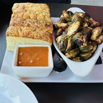 Rocco's - Pork Belly Brussel Sprouts with sauce on the side - Bars Near Me - Seattle, Washington Rocco's - Pork Belly Brussel Sprouts with sauce on the side - Bars Near Me - Seattle, Washington