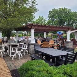Poly furniture and Artisan pergola on outdoor patio.