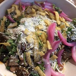 Burrito bowl with grilled steak, pinto beans, pickled red onions, tortilla strips, fresh cilantro, shredded cheese, and guac Burrito bowl with grilled steak, pinto beans, pickled red onions, tortilla strips, fresh cilantro, shredded cheese, and guac