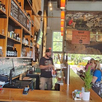 Whistler Brewing - a man and a woman sitting at a bar - Breweries Near Me - Whistler, British Columbia Whistler Brewing - a man and a woman sitting at a bar - Breweries Near Me - Whistler, British Columbia