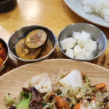 K Style Kitchen - (L-R) cucumber kimchi, pickled cukes, pickled radish, Napa cabbage kimchi. All of them very flavorful! - Korean Near Me - Albuquerque, New Mexico