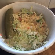 Photo of Langer's Delicatessen - Los Angeles, CA, United States. A side of Coleslaw, Potato Salad and Pickles.