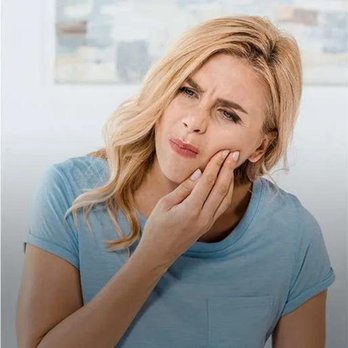 Dunwin Dental - Dental Emergencies in Mississauga - a blonde haired woman with hurting teeth touching her left cheek with her right hand - General Dentistry Near Me - Mississauga, Ontario Dunwin Dental - Dental Emergencies in Mississauga - a blonde haired woman with hurting teeth touching her left cheek with her right hand - General Dentistry Near Me - Mississauga, Ontario