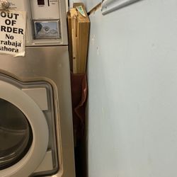 Wash Depot Laundromat - Wood holding washer steady.