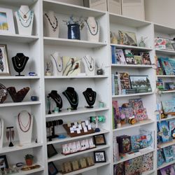 Usher Gallery - Our back wall of jewelry display, adults and kids books by local authors, and handcrafted childrens items.