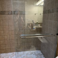 Kiss My Glass Cleaning Services - Shower door after cleaning removing water spots.