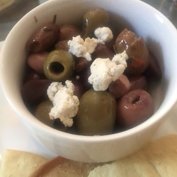 Treehouse Bar & Lounge - The warm olives are sautéed in garlic, fresh herbs & olive oil served with warm pink peppercorn goat cheese on top. Excellent. Get it. - Bars Near Me - Taos, New Mexico