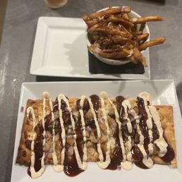 Pork belly Flatbread with a ranch drizzle and a mini poutine