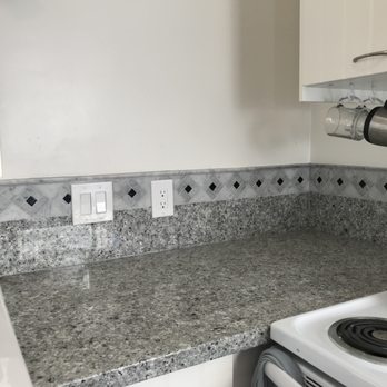 Tim O Tile - a kitchen counter with a kettle on it - General Contractors Near Me