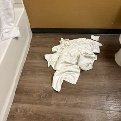 Extended Stayamerica - Pile of dirty towels on the floor that the front desk stated they will put away but did not