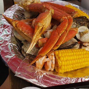 Silver Dollar - The teens Seafood Medley was out of this world!  Oysters crab legs, shrimp, clams, sausage, corn on the cob. He was in heaven - Seafood Near Me - Carolina Beach, North Carolina