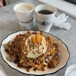 Mad Hatter Hash (or something like that). Delicious potatoes, brisket, cheese, and sirracha.