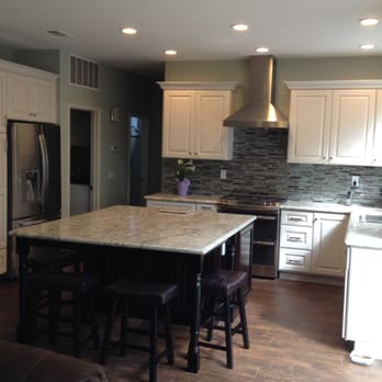 Huntington Cabinets - Built in fridge, bigger island and new ceramic tiles floors that look like wood. - Interior Design Near Me - Huntington Beach, California