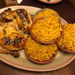 Nando's - Whole chicken cut into quarters and sides of rice