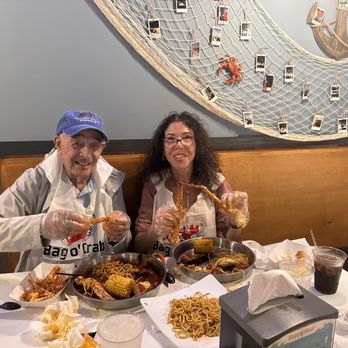Bag O’ Crab - Two people enjoying their meal - Seafood Near Me - Goodyear, Arizona Bag O’ Crab - Two people enjoying their meal - Seafood Near Me - Goodyear, Arizona