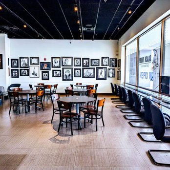 Black Ivory Café - tables, chairs, and pictures on the wall - Coffee & Tea Near Me - Raleigh, North Carolina