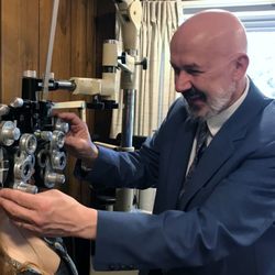Kofos Family Eye Care - Dr. Nicholas Kofos working with a patient.