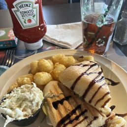 Apple and Brie panini with cole slaw and air fried tots. Local copperpoint beer.