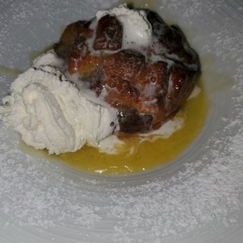 P.J. Clarke's - The cream exited the top of the bread pudding, right before this picture. Very good bread pudding. The whiskey is present. - American Near Me - Washington, DC, District of Columbia