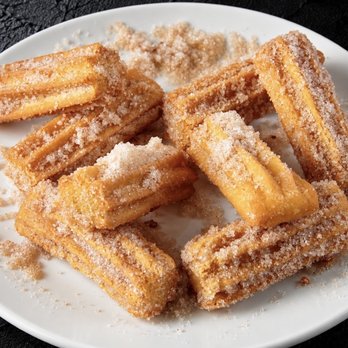 Fuego Cravings - Golden, filled bite-sized churros coated in cinnamon sugar, served with your choice of dip. - Mexican Near Me - Covina, California Fuego Cravings - Golden, filled bite-sized churros coated in cinnamon sugar, served with your choice of dip. - Mexican Near Me - Covina, California
