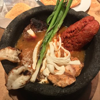 Cilantro - The Molcajete Azteca. Shrimp (bottom left), Chicken (bottom right), Chorizo (top right), Steak (top left). Great dish! - Mexican Near Me - New York, New York