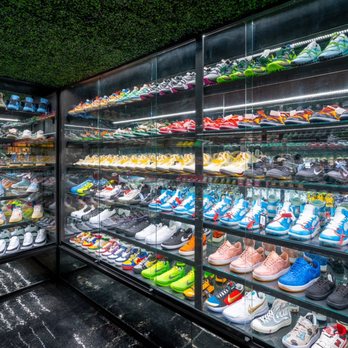 Private Selection - Sneaker ready. - A glass display case showcases a wide selection of sneakers in different colors and styles, arranged on multiple shelves. - Men's Clothing Near Me - Dallas, Texas