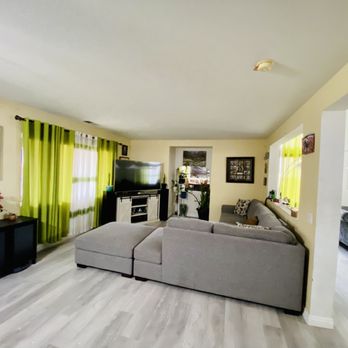 Daniel’s Flooring - a living room with a couch and a television - Flooring Near Me