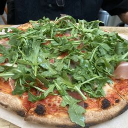 Exuberant volume of arugula tops an otherwise good pizza Exuberant volume of arugula tops an otherwise good pizza