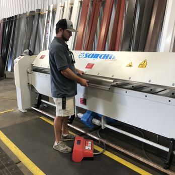 A worker operating machinery, highlighting practical applications of sheet metal work.