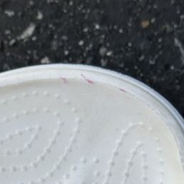 Red nail polish that was painted on my white flip flop