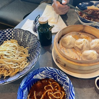 Tasty Moment - Half eaten sorry - cold sesame noodles on the left, pork soup dumplings in the middle and the beef noodle soup in top right corner - Shanghainese Near Me - Edison, New Jersey Tasty Moment - Half eaten sorry - cold sesame noodles on the left, pork soup dumplings in the middle and the beef noodle soup in top right corner - Shanghainese Near Me - Edison, New Jersey