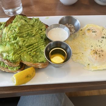 Lake St Cafe - Avocado toast with two over easy eggs. Cute presentation but one slice was plenty as the texture and taste is a bit bland. - Breakfast & Brunch Near Me - Addison, Illinois Lake St Cafe - Avocado toast with two over easy eggs. Cute presentation but one slice was plenty as the texture and taste is a bit bland. - Breakfast & Brunch Near Me - Addison, Illinois