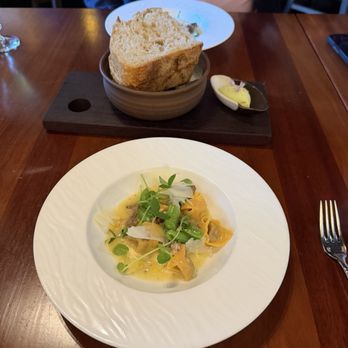Altura - Pasta wagyu ravioli with sweet greens in a cheesy sauce and sourdough bread with seasoned butter. - Italian Near Me - Seattle, Washington