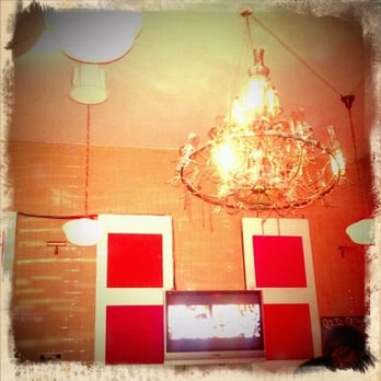 The Suffolk - a chandelier and a television in a room - Bars Near Me - New York, New York The Suffolk - a chandelier and a television in a room - Bars Near Me - New York, New York