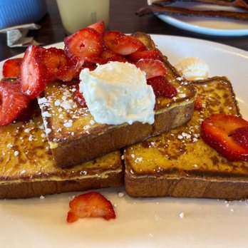 Kihei Caffe Lahaina - Strawberry and cream French toast with crispy bacon in the background. - Breakfast & Brunch Near Me - Lahaina, Hawaii