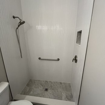 Howard Tile Installations - Shower replaced a bathtub and the tile goes 10 feet to the ceiling. - Flooring Near Me