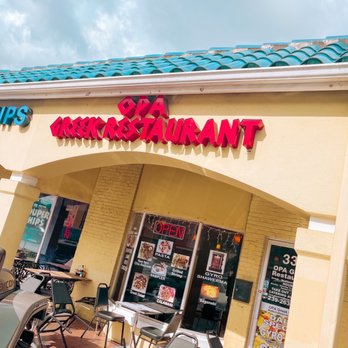 Opa Greek Restaurant - Out front. (Sun probably makes the chairs hot, so they're tilted.) - Greek Near Me - Naples, Florida