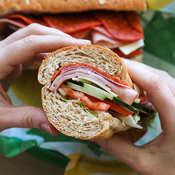 Subway - a person holding a sandwich in their hand - Sandwiches Near Me - Junction City, Kansas