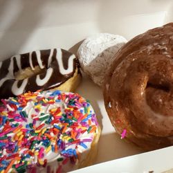 Donut Kolache Palace - Sprinkles with vanilla icing and lemon filling Chocolate doughnut cinnamon roll